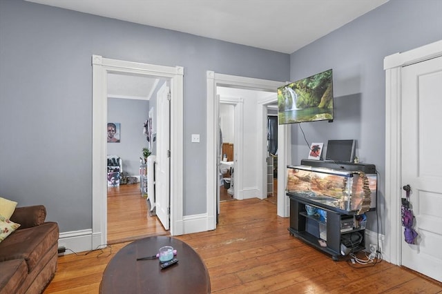 living room featuring light wood-style flooring and baseboards