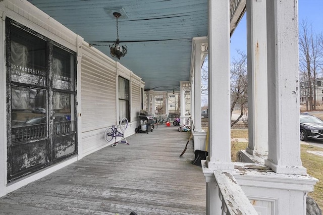 wooden terrace featuring a porch and grilling area