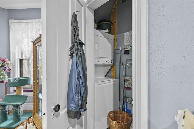 clothes washing area with laundry area and stacked washer and clothes dryer