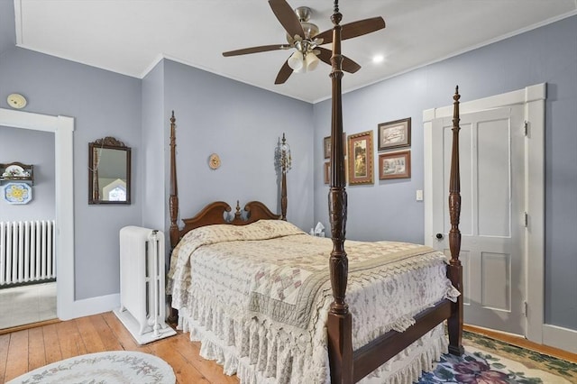 bedroom with crown molding, light wood-style flooring, radiator, and ceiling fan