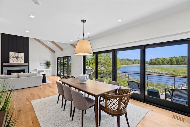 38 Old Shipyard Ln, Hanover, MA 02339 - dining space with a water view, light wood-style flooring, recessed lighting, a fireplace, and french doors
