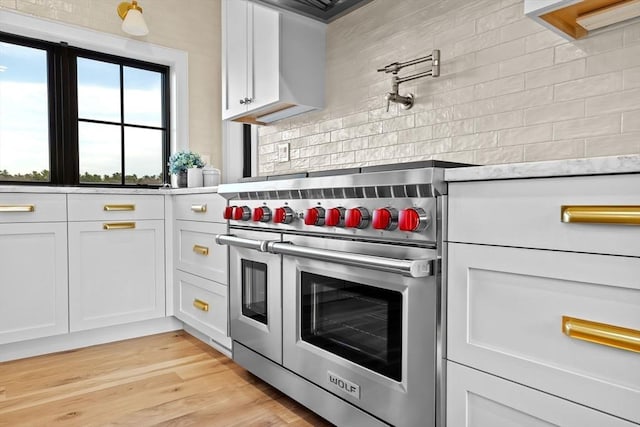 38 Old Shipyard Ln, Hanover, MA 02339 - kitchen with double oven range, decorative backsplash, white cabinets, and light countertops