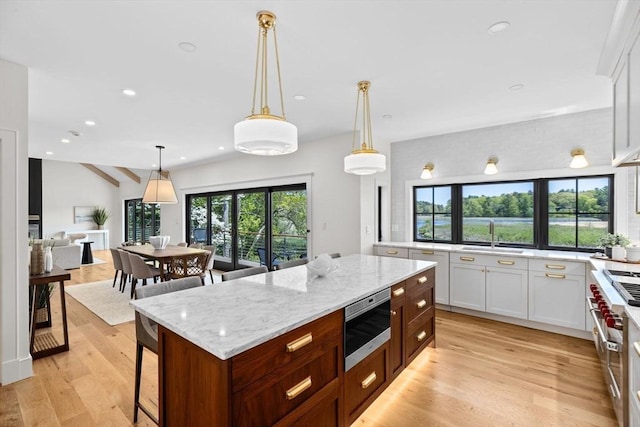 38 Old Shipyard Ln, Hanover, MA 02339 - kitchen featuring a sink, light stone countertops, recessed lighting, a center island, and white cabinetry