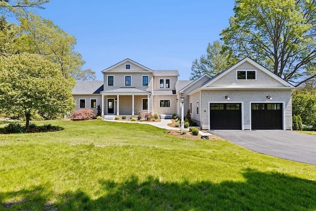 38 Old Shipyard Ln, Hanover, MA 02339 - view of front of house with driveway, a porch, a garage, and a front yard