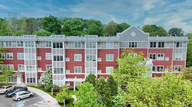 35 Commonwealth Ave Unit 404, Newton, MA 02467 - view of property featuring uncovered parking and view of scattered trees