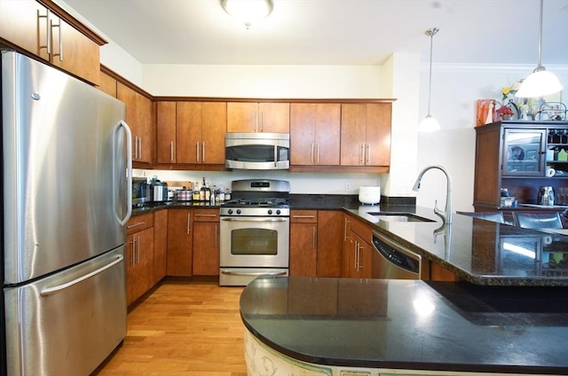 35 Commonwealth Ave Unit 404, Newton, MA 02467 - kitchen with stainless steel appliances, a sink, a peninsula, and brown cabinetry