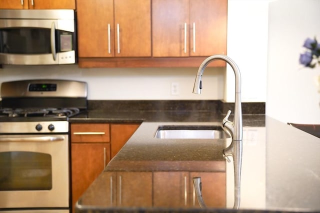 35 Commonwealth Ave Unit 404, Newton, MA 02467 - kitchen with stainless steel appliances, a sink, and brown cabinets