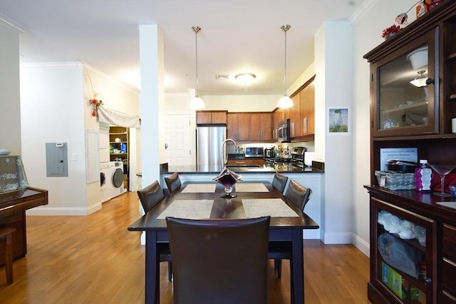 35 Commonwealth Ave Unit 404, Newton, MA 02467 - dining room with washing machine and clothes dryer, wood finished floors, baseboards, and crown molding