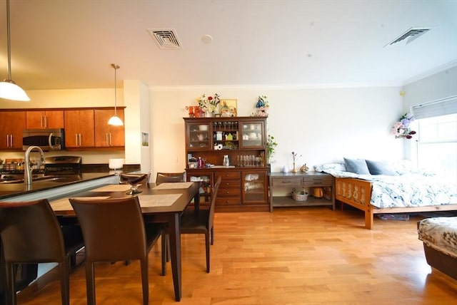 35 Commonwealth Ave Unit 404, Newton, MA 02467 - dining room with crown molding and light wood-style floors