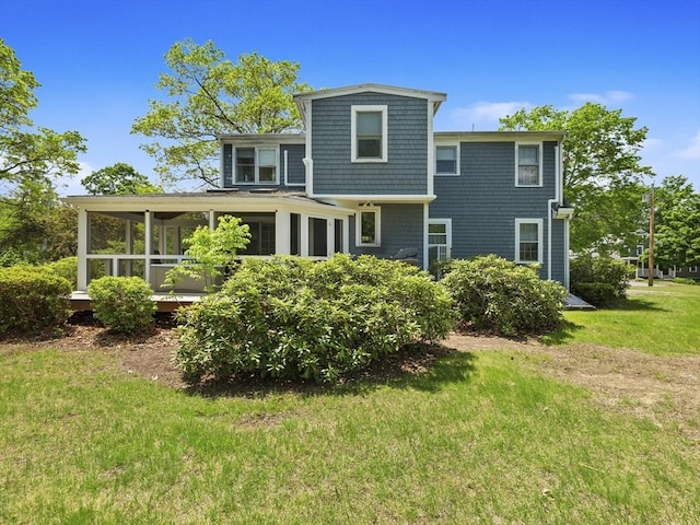 34 Kinsley Rd, Acton, MA 01720 - back of property with a sunroom and a lawn