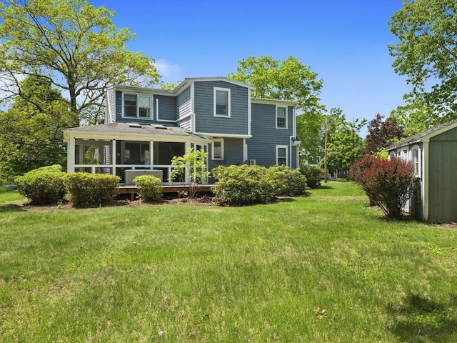 34 Kinsley Rd, Acton, MA 01720 - back of property with a sunroom and a lawn