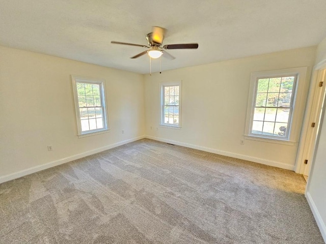 unfurnished room featuring light carpet and ceiling fan