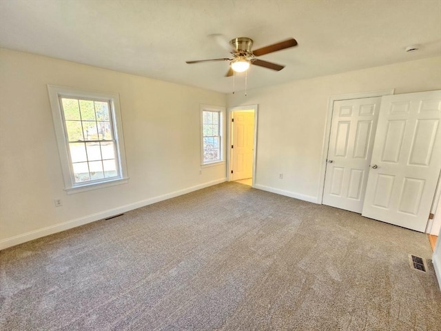 unfurnished bedroom with ceiling fan and carpet floors