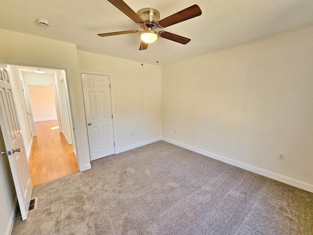 unfurnished bedroom with light carpet and ceiling fan