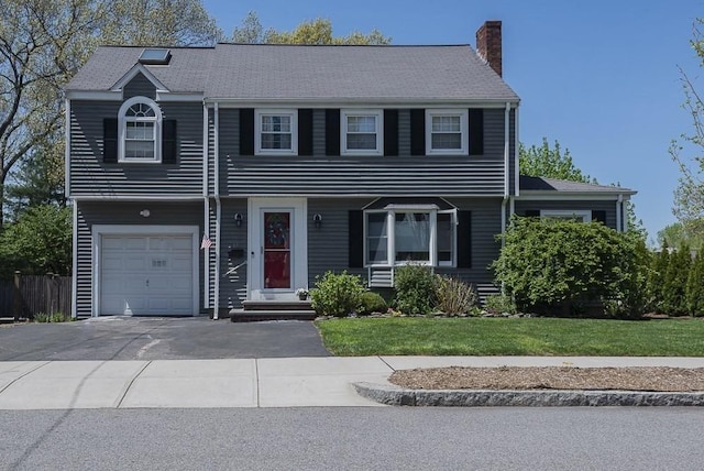 17 Woodcliff Rd, Quincy, MA 02169 - view of front of property with a chimney, a garage, a front yard, and driveway