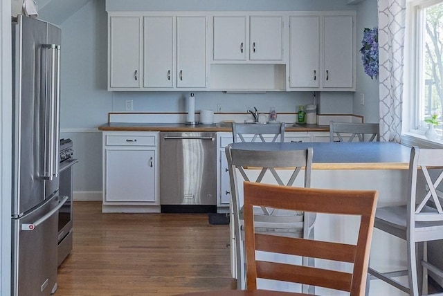 17 Woodcliff Rd, Quincy, MA 02169 - kitchen featuring stainless steel appliances, dark wood finished floors, white cabinetry, and baseboards