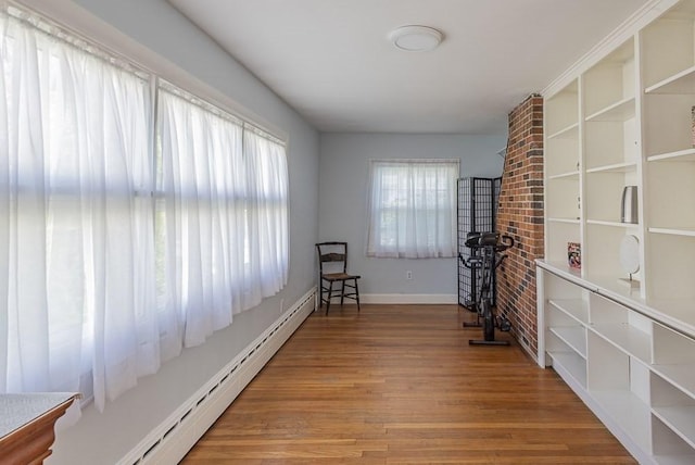 17 Woodcliff Rd, Quincy, MA 02169 - living area with wood finished floors, baseboards, and a baseboard heating unit