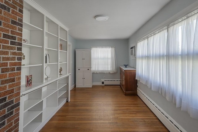 17 Woodcliff Rd, Quincy, MA 02169 - unfurnished bedroom with a baseboard radiator, baseboard heating, dark wood-style flooring, baseboards, and a wall mounted air conditioner