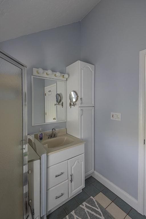 17 Woodcliff Rd, Quincy, MA 02169 - full bath with lofted ceiling, vanity, tile patterned floors, baseboards, and an enclosed shower