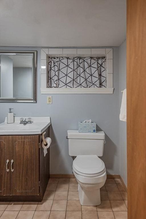 17 Woodcliff Rd, Quincy, MA 02169 - half bathroom featuring baseboards, vanity, toilet, and tile patterned flooring
