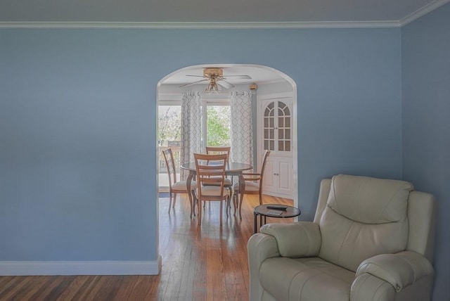 17 Woodcliff Rd, Quincy, MA 02169 - dining room with arched walkways, hardwood / wood-style floors, baseboards, ornamental molding, and ceiling fan