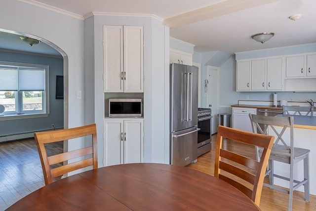 17 Woodcliff Rd, Quincy, MA 02169 - kitchen featuring high end appliances, light wood-style flooring, white cabinets, crown molding, and a baseboard radiator