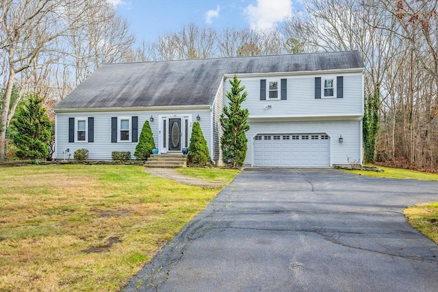 view of front of home with a garage and a front lawn