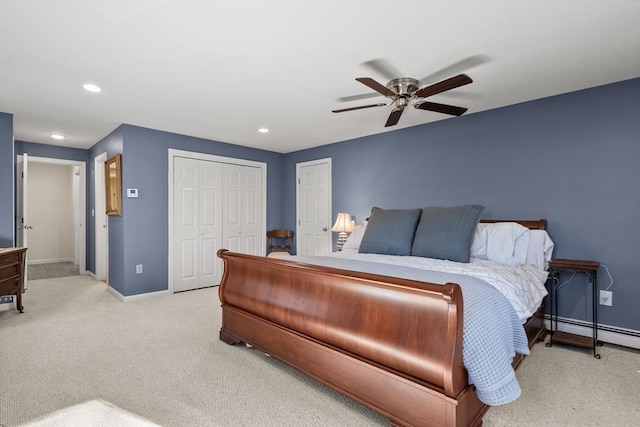 bedroom with light colored carpet, ceiling fan, and a baseboard heating unit