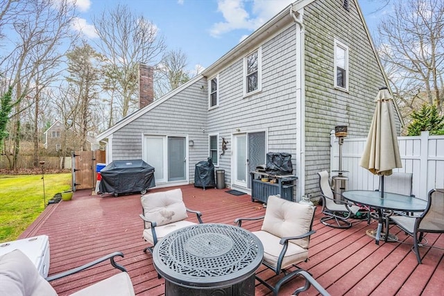 wooden deck featuring an outdoor hangout area and a grill