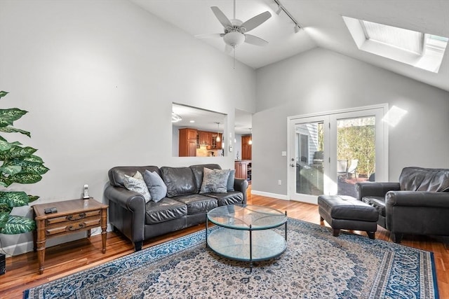 living room featuring hardwood / wood-style floors, ceiling fan, and lofted ceiling