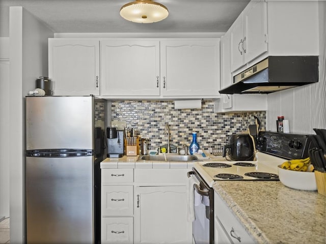 kitchen featuring a sink, freestanding refrigerator, under cabinet range hood, white cabinetry, and electric stove