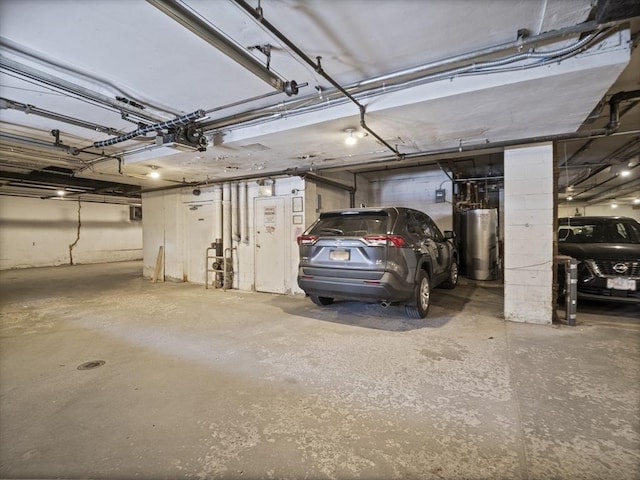 parking garage with gas water heater and a garage door opener