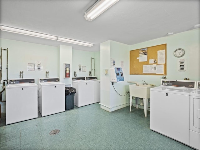 community laundry room featuring separate washer and dryer, tile patterned floors, and a sink