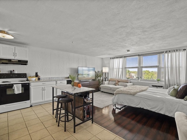 bedroom featuring light tile patterned floors and a textured ceiling