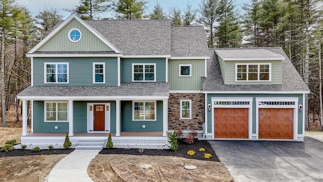 view of front facade with a garage and a porch