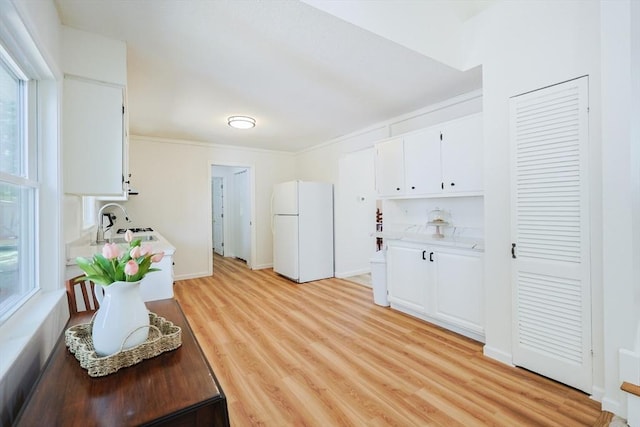 13 Dixon Cir, Holliston, MA 01746 - kitchen with freestanding refrigerator, a sink, white cabinetry, light countertops, and light wood finished floors