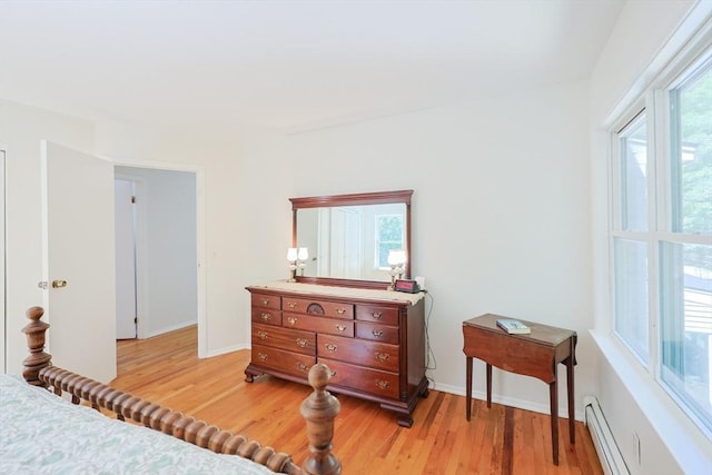13 Dixon Cir, Holliston, MA 01746 - bedroom with light wood finished floors, a baseboard heating unit, and baseboards
