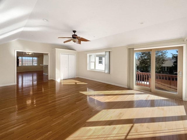 interior space featuring baseboards, lofted ceiling, and wood finished floors