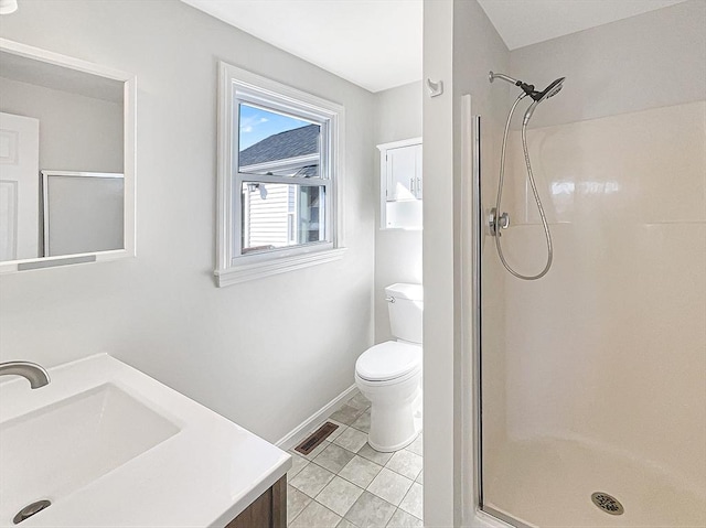 bathroom featuring vanity, toilet, and a stall shower