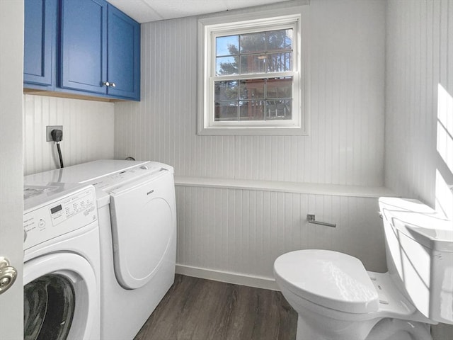 laundry room featuring separate washer and dryer, dark wood-style flooring, and laundry area