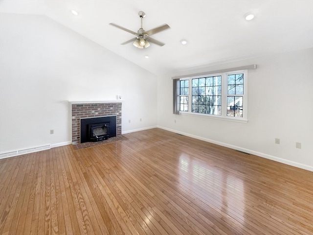 unfurnished living room featuring lofted ceiling, baseboards, and light wood-type flooring