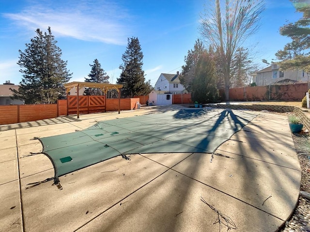 view of swimming pool with a patio, a fenced in pool, and a fenced backyard