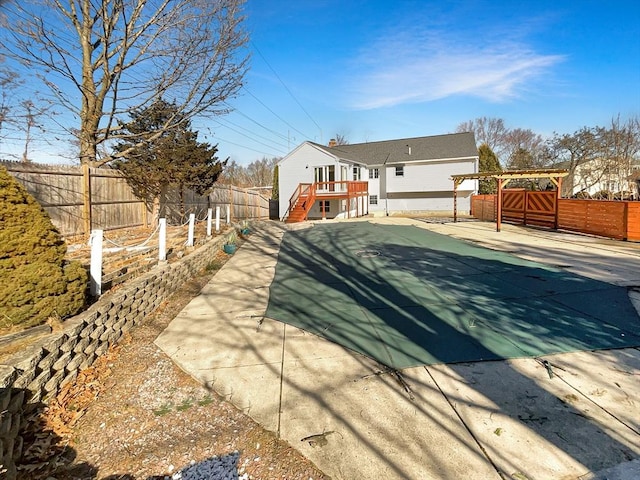 back of house with a fenced backyard