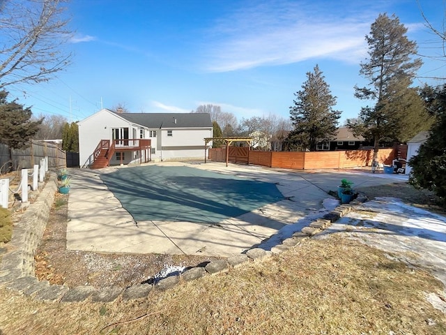 view of swimming pool featuring a fenced backyard and stairs