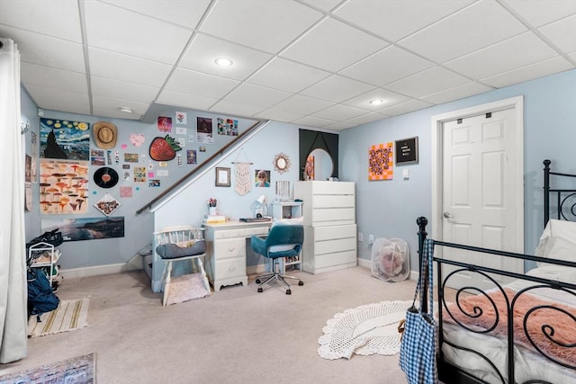 carpeted bedroom with a paneled ceiling