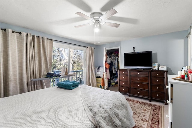 bedroom with a closet, ceiling fan, and a spacious closet