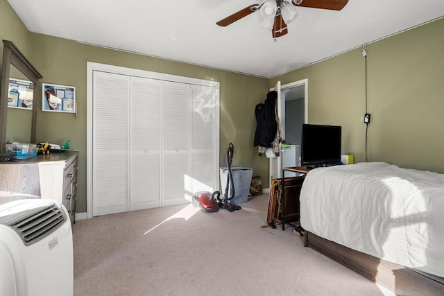 carpeted bedroom featuring a closet and ceiling fan