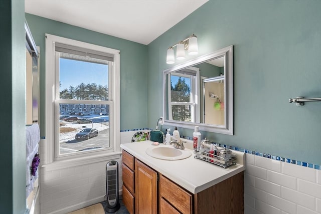 bathroom with vanity and tile walls