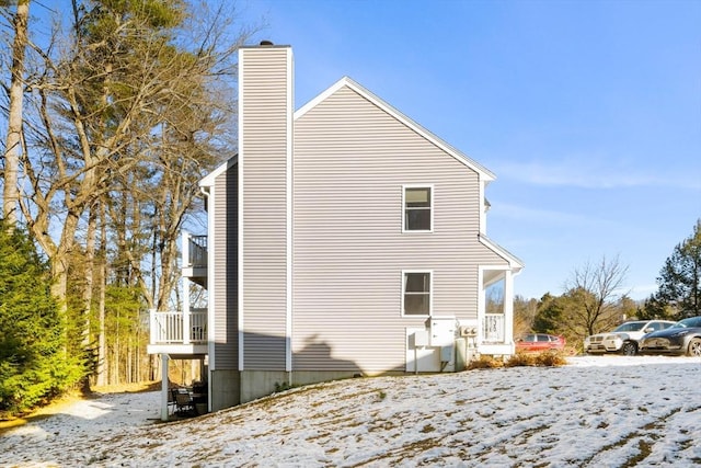 view of snow covered exterior with a balcony