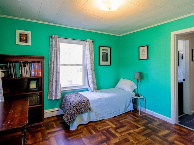 bedroom featuring a baseboard heating unit, baseboards, and ornamental molding